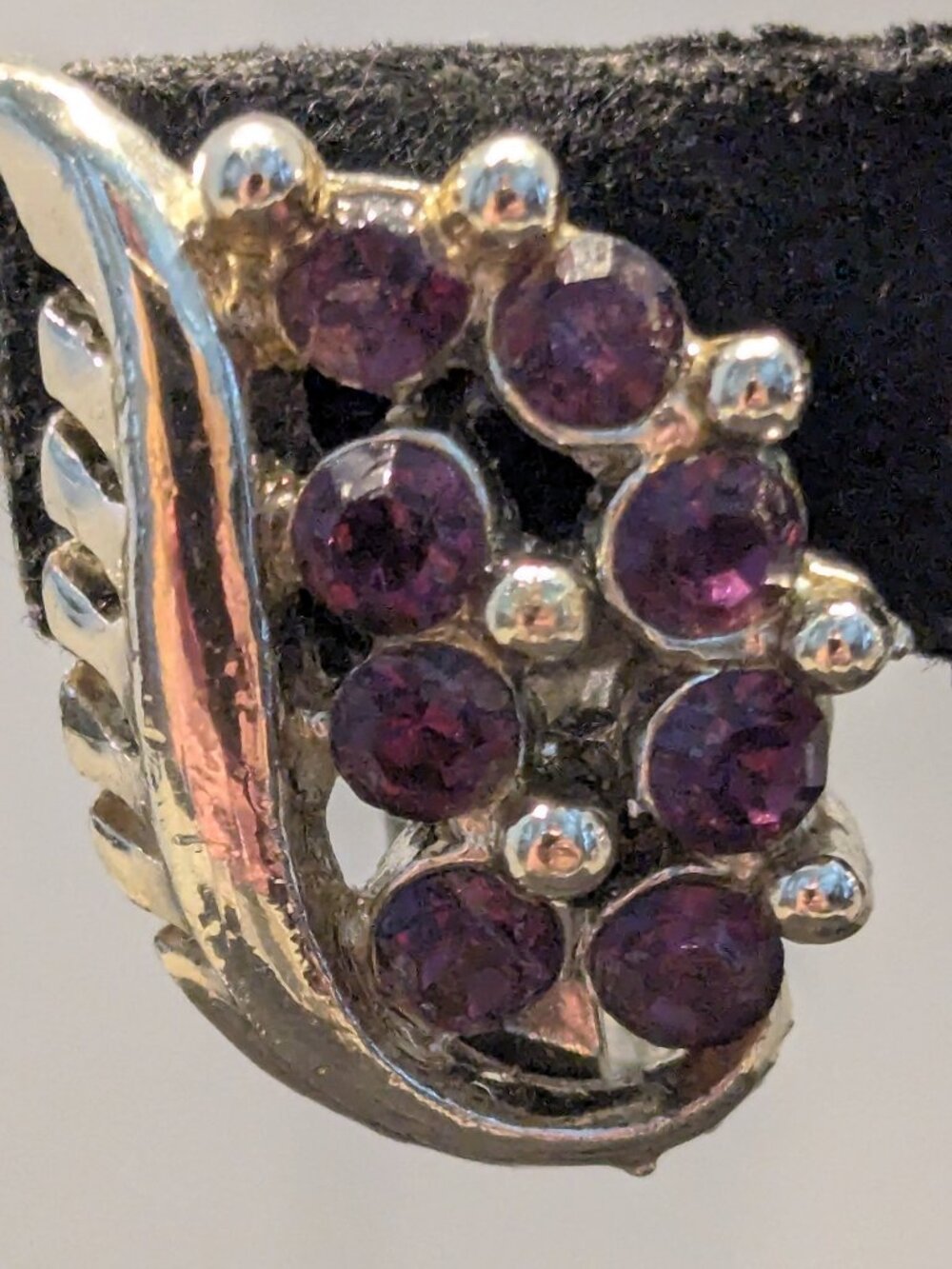 Vintage clip-on on earrings featuring a cluster of deep purple faceted stones